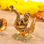 metal bal krishn, baby krishna playing flute and sitting on peacock mor